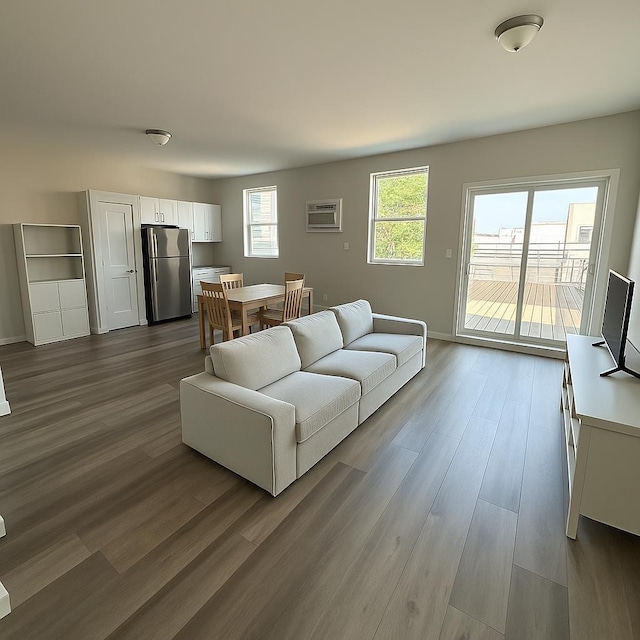 512 Monastery Pl, Union City, NJ 07087 - living area featuring a wall unit AC and dark wood-style floors
