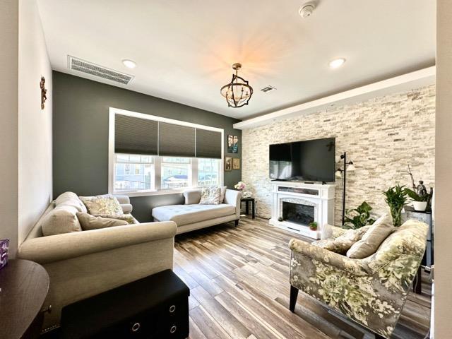 living room with hardwood / wood-style floors and an inviting chandelier