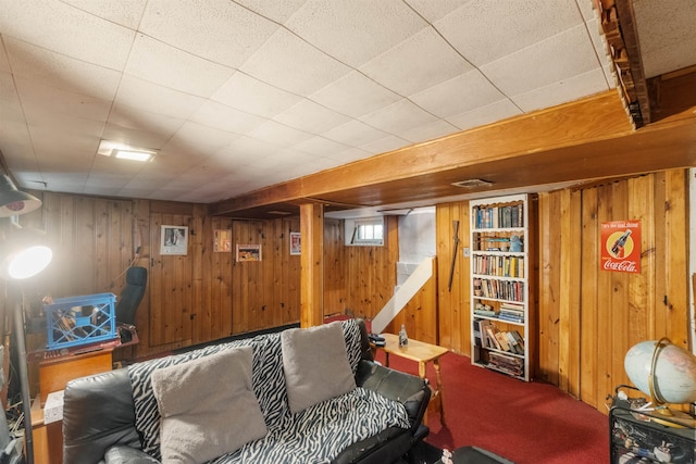 living room featuring carpet and wood walls