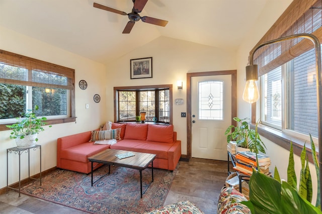 interior space with wood finished floors, baseboards, ceiling fan, and vaulted ceiling