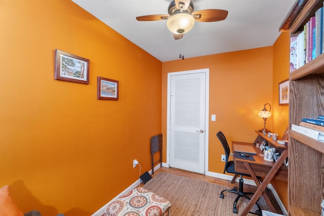 home office with baseboards and a ceiling fan