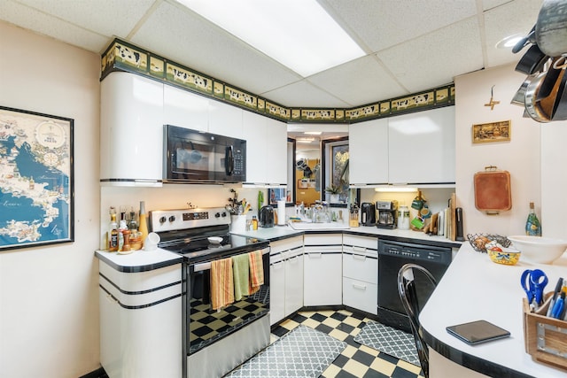 kitchen with white cabinetry, black appliances, a drop ceiling, and tile patterned floors