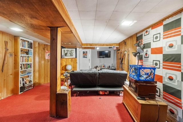 interior space with carpet and wood walls