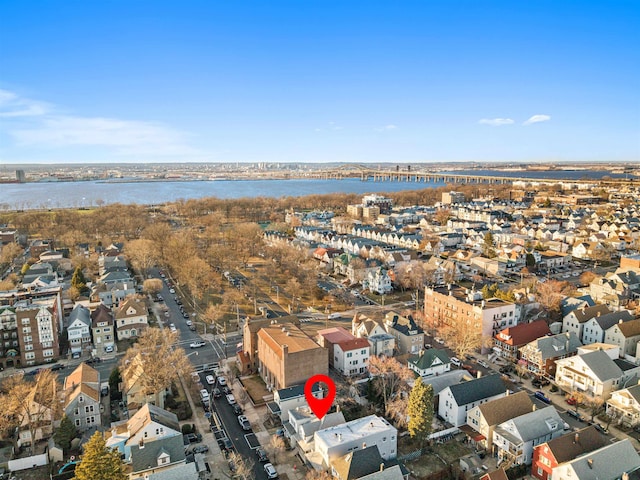 drone / aerial view featuring a water view and a residential view