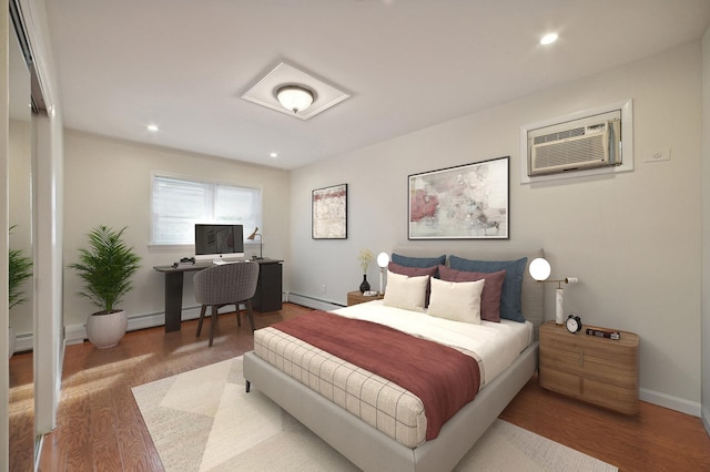 2105 Palisade Ave, Union City, NJ 07087 - bedroom featuring a baseboard radiator, a wall unit AC, wood finished floors, a desk, and recessed lighting