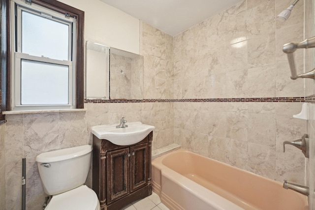 2105 Palisade Ave, Union City, NJ 07087 - bathroom featuring vanity, tile walls, toilet, shower / washtub combination, and tile patterned flooring