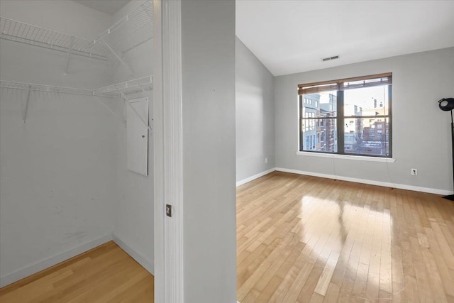 spacious closet with wood-type flooring and visible vents