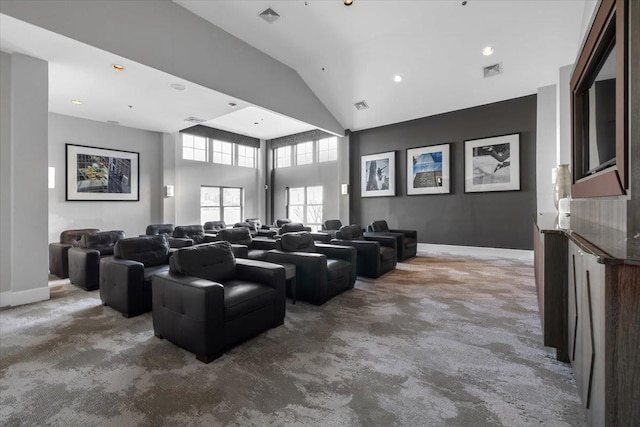 carpeted cinema room featuring high vaulted ceiling, baseboards, and visible vents