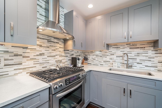 1025 Maxwell Ln Unit 304, Hoboken, NJ 07030 - kitchen featuring gas range, a sink, light countertops, gray cabinetry, and wall chimney exhaust hood