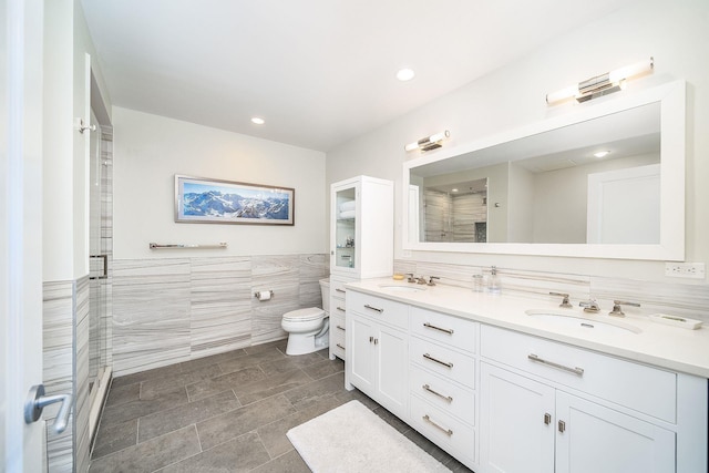 1025 Maxwell Ln Unit 304, Hoboken, NJ 07030 - full bathroom featuring double vanity, tile walls, a stall shower, a sink, and toilet