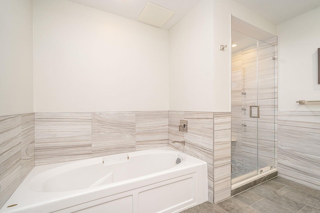 1025 Maxwell Ln Unit 304, Hoboken, NJ 07030 - full bathroom featuring tile walls, a wainscoted wall, a bath, and a stall shower
