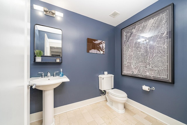 1025 Maxwell Ln Unit 304, Hoboken, NJ 07030 - half bath with visible vents, a sink, baseboards, and toilet