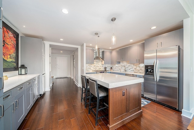 1025 Maxwell Ln Unit 304, Hoboken, NJ 07030 - kitchen with wall chimney range hood, stainless steel fridge with ice dispenser, light countertops, gray cabinets, and decorative backsplash