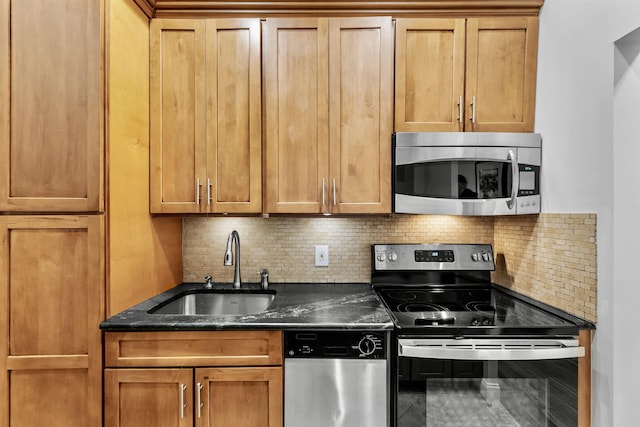 264 9th St Unit 2R, Jersey City, NJ 07302 - kitchen featuring appliances with stainless steel finishes, a sink, backsplash, and brown cabinets