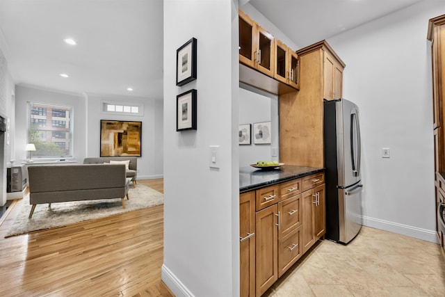 264 9th St Unit 2R, Jersey City, NJ 07302 - kitchen featuring freestanding refrigerator, baseboards, glass insert cabinets, brown cabinetry, and recessed lighting
