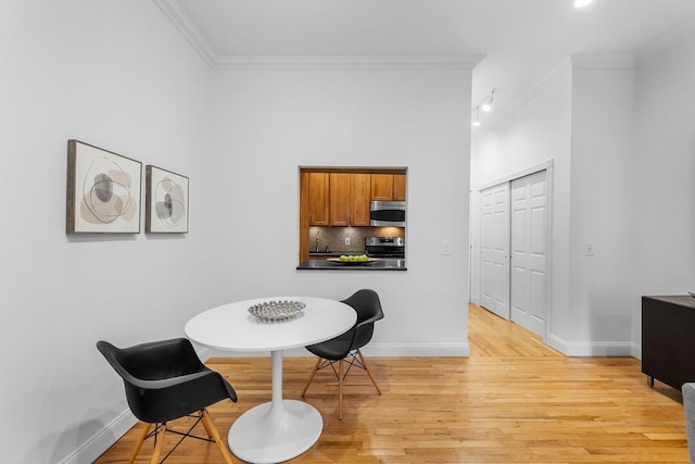 264 9th St Unit 2R, Jersey City, NJ 07302 - dining room featuring light wood finished floors, baseboards, and ornamental molding