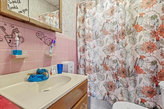 full bathroom with curtained shower, toilet, tile walls, and vanity