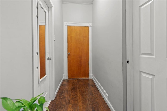 hallway with baseboards and wood finished floors