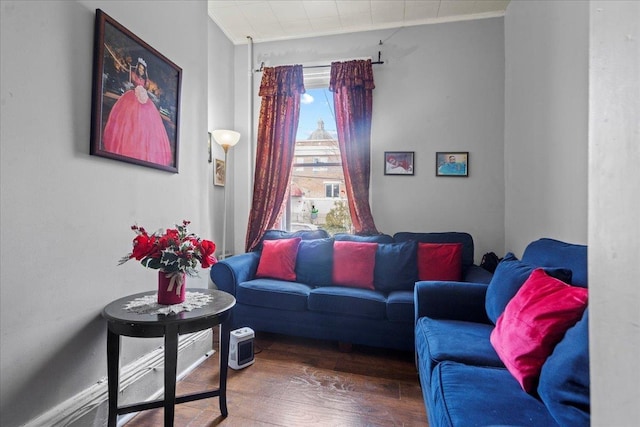 living room with ornamental molding and wood finished floors