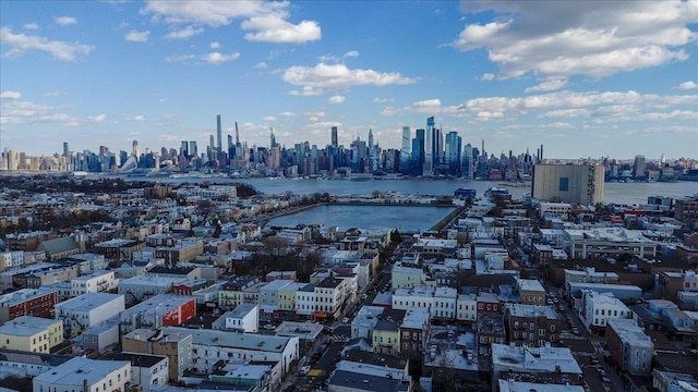 birds eye view of property featuring a view of city and a water view