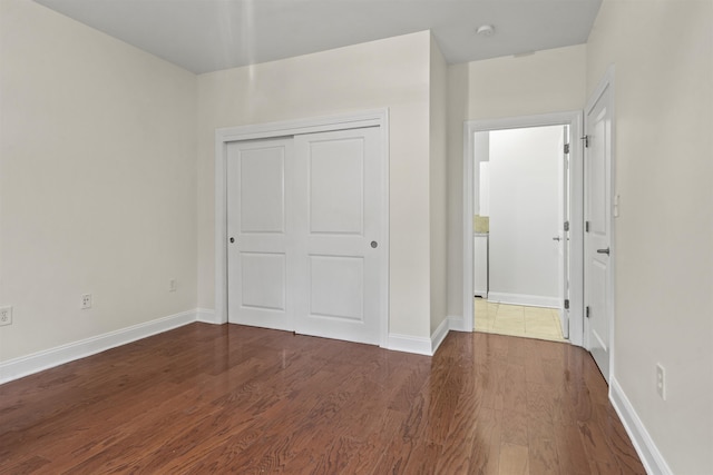 20 Avenue At Port Imperial Unit 102, West New York, NJ 07093 - unfurnished bedroom featuring dark wood-style floors and a closet