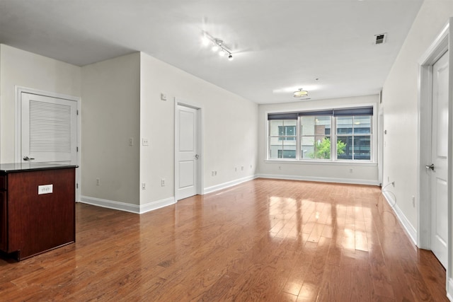 20 Avenue At Port Imperial Unit 102, West New York, NJ 07093 - unfurnished room featuring wood finished floors and rail lighting