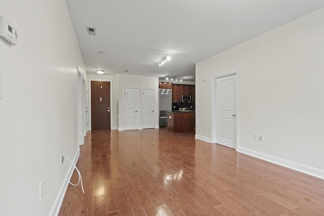 20 Avenue At Port Imperial Unit 102, West New York, NJ 07093 - unfurnished living room featuring light wood finished floors and baseboards