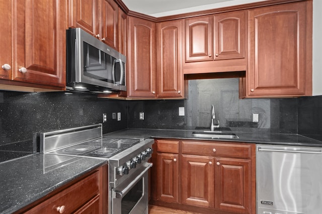 20 Avenue At Port Imperial Unit 102, West New York, NJ 07093 - kitchen with appliances with stainless steel finishes, decorative backsplash, dark stone countertops, and brown cabinetry