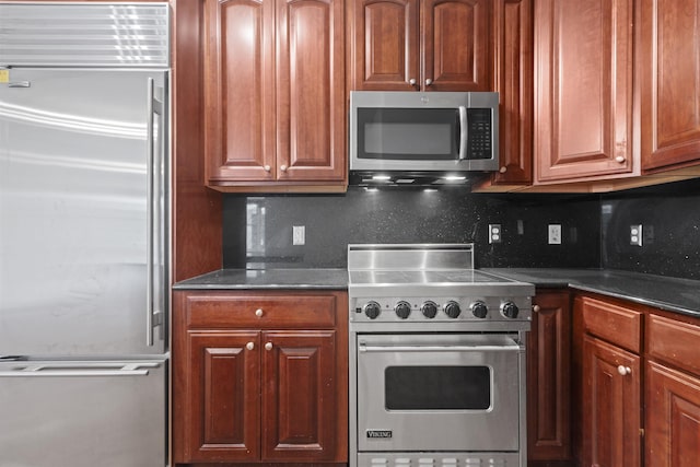 20 Avenue At Port Imperial Unit 102, West New York, NJ 07093 - kitchen with high end appliances, decorative backsplash, dark stone counters, and brown cabinetry
