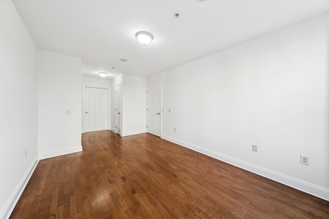 45 Broadway Unit 204, Jersey City, NJ 07306 - spare room featuring dark wood-type flooring, baseboards, and fire sprinkler in ceiling