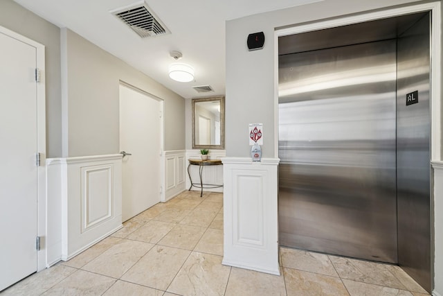 45 Broadway Unit 204, Jersey City, NJ 07306 - hall with elevator, wainscoting, and light tile patterned flooring