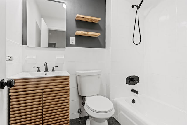 422 Grand St Unit 4, Hoboken, NJ 07030 - full bath featuring toilet, vanity, washtub / shower combination, a wainscoted wall, and tile walls