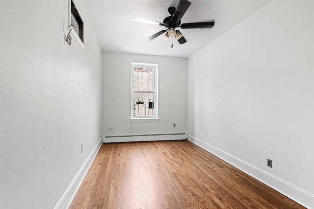 422 Grand St Unit 4, Hoboken, NJ 07030 - empty room featuring baseboard heating, wood finished floors, a ceiling fan, and baseboards