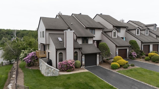 12 Davey Dr, West Orange, NJ 07052 - view of front of home with a shingled roof, asphalt driveway, and a front yard