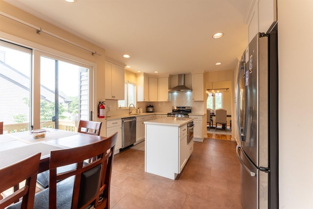 12 Davey Dr, West Orange, NJ 07052 - kitchen with stainless steel appliances, wall chimney exhaust hood, light countertops, healthy amount of natural light, and recessed lighting