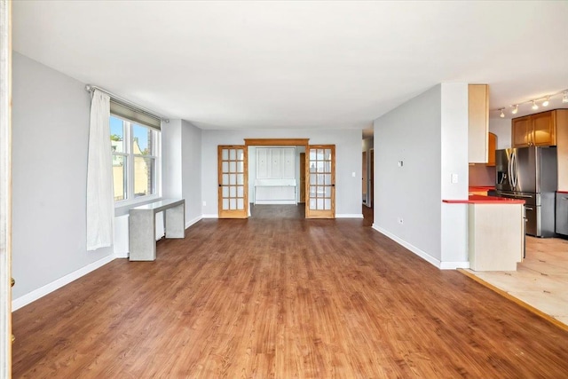 380 Mountain Rd Unit 213, Union City, NJ 07087 - unfurnished living room with light wood-style flooring and baseboards