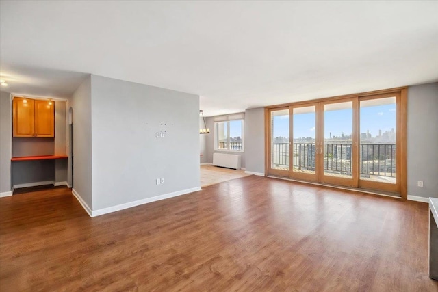 380 Mountain Rd Unit 213, Union City, NJ 07087 - unfurnished living room with wood finished floors and radiator heating unit