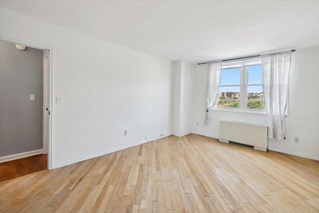 380 Mountain Rd Unit 213, Union City, NJ 07087 - unfurnished room with radiator heating unit and wood finished floors