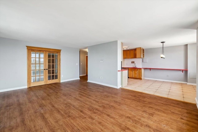 380 Mountain Rd Unit 213, Union City, NJ 07087 - unfurnished living room featuring light wood-type flooring and french doors