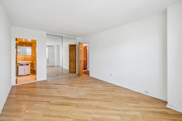 380 Mountain Rd Unit 213, Union City, NJ 07087 - unfurnished bedroom featuring light wood-style flooring, ensuite bathroom, and a closet