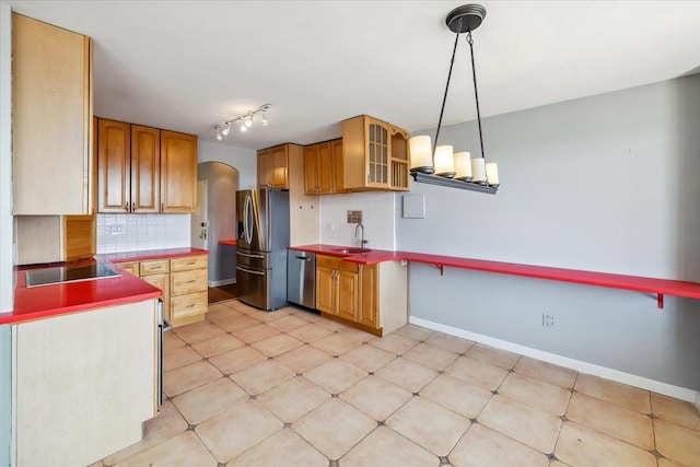 380 Mountain Rd Unit 213, Union City, NJ 07087 - kitchen featuring appliances with stainless steel finishes, arched walkways, tasteful backsplash, glass insert cabinets, and rail lighting