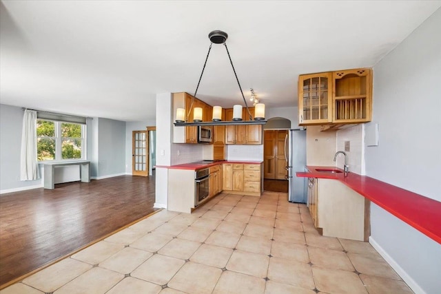 380 Mountain Rd Unit 213, Union City, NJ 07087 - kitchen featuring appliances with stainless steel finishes, open floor plan, light flooring, backsplash, and glass insert cabinets