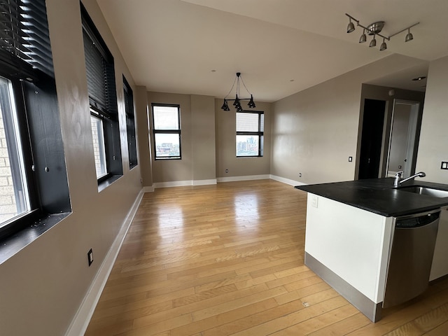 4 Beacon Way Unit 1001, Jersey City, NJ 07304 - unfurnished dining area with a sink, light wood-style floors, and baseboards