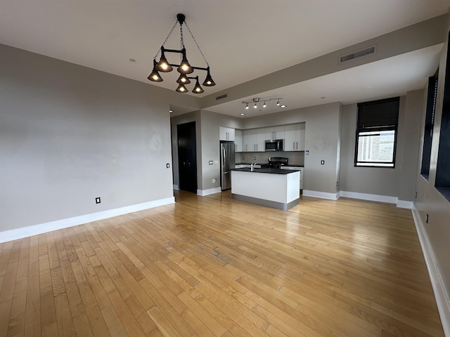4 Beacon Way Unit 1001, Jersey City, NJ 07304 - unfurnished living room featuring light wood finished floors, baseboards, and a chandelier