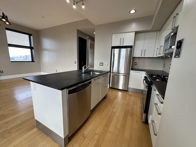 4 Beacon Way Unit 1001, Jersey City, NJ 07304 - kitchen with appliances with stainless steel finishes, a sink, dark countertops, and light wood-type flooring