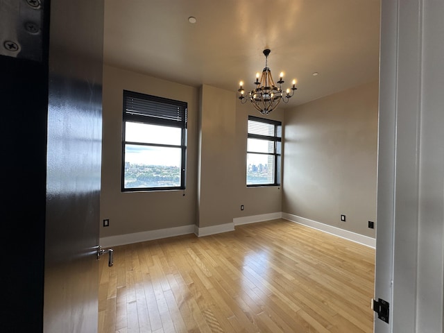 4 Beacon Way Unit 1001, Jersey City, NJ 07304 - unfurnished room with a chandelier, light wood-type flooring, and baseboards