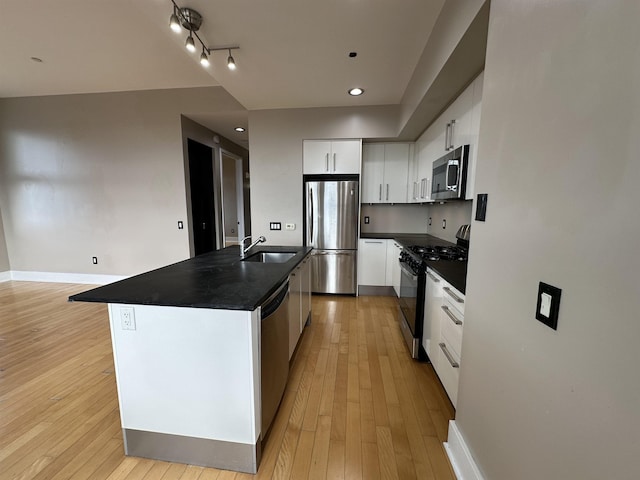 4 Beacon Way Unit 1001, Jersey City, NJ 07304 - kitchen with appliances with stainless steel finishes, dark countertops, a sink, white cabinetry, and light wood-type flooring