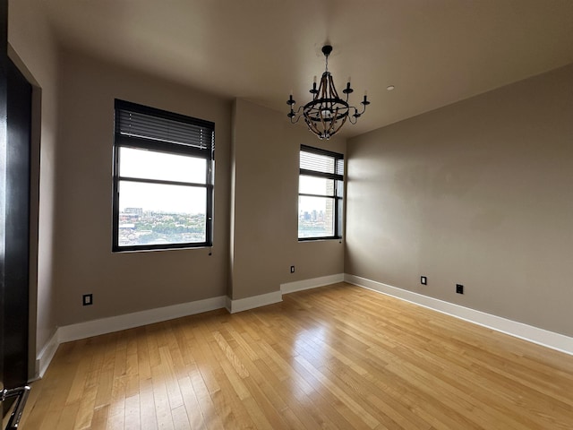 4 Beacon Way Unit 1001, Jersey City, NJ 07304 - empty room with a chandelier, light wood-style flooring, and baseboards