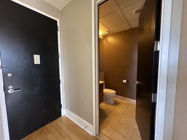 4 Beacon Way Unit 1001, Jersey City, NJ 07304 - bathroom featuring toilet, baseboards, vanity, a drop ceiling, and tile patterned floors