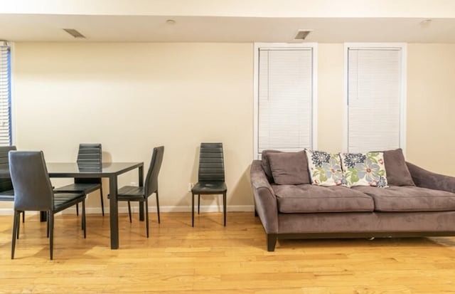 interior space with light wood-style floors, baseboards, and visible vents